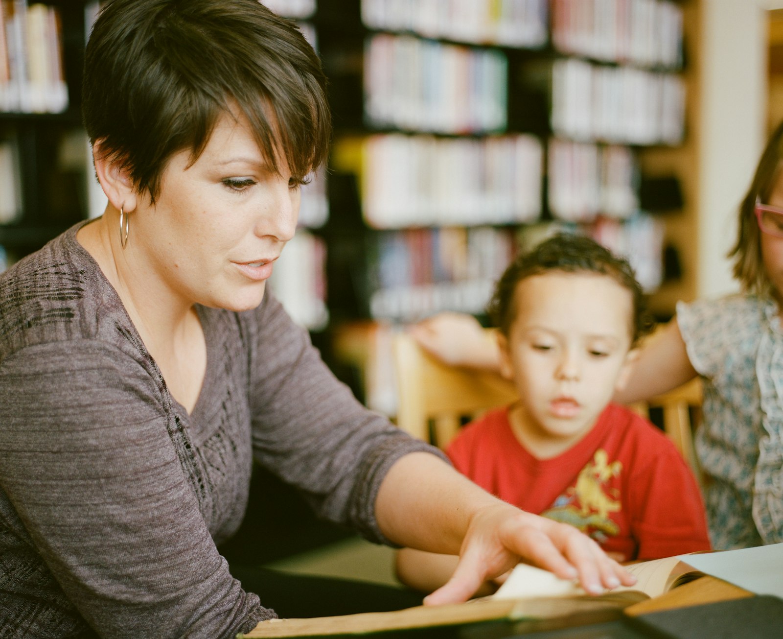 A teacher reading a book with a young child at a licensed child care center